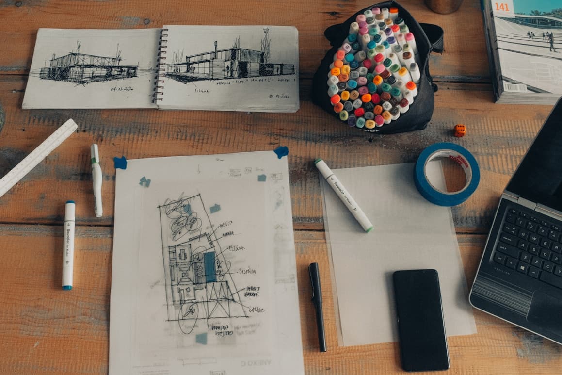 Architectural sketches and design tools on a desk